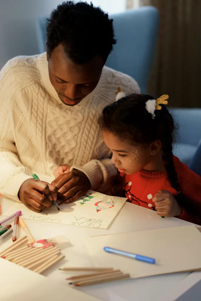 Dad or father and daughter coloring or writing 